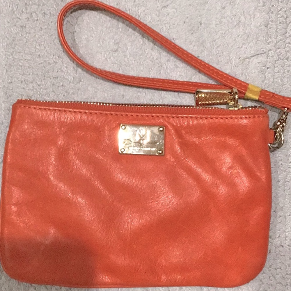 Nwot Rebecca Minkoff wristlet in orange leather. Has broken strap. Noted tape